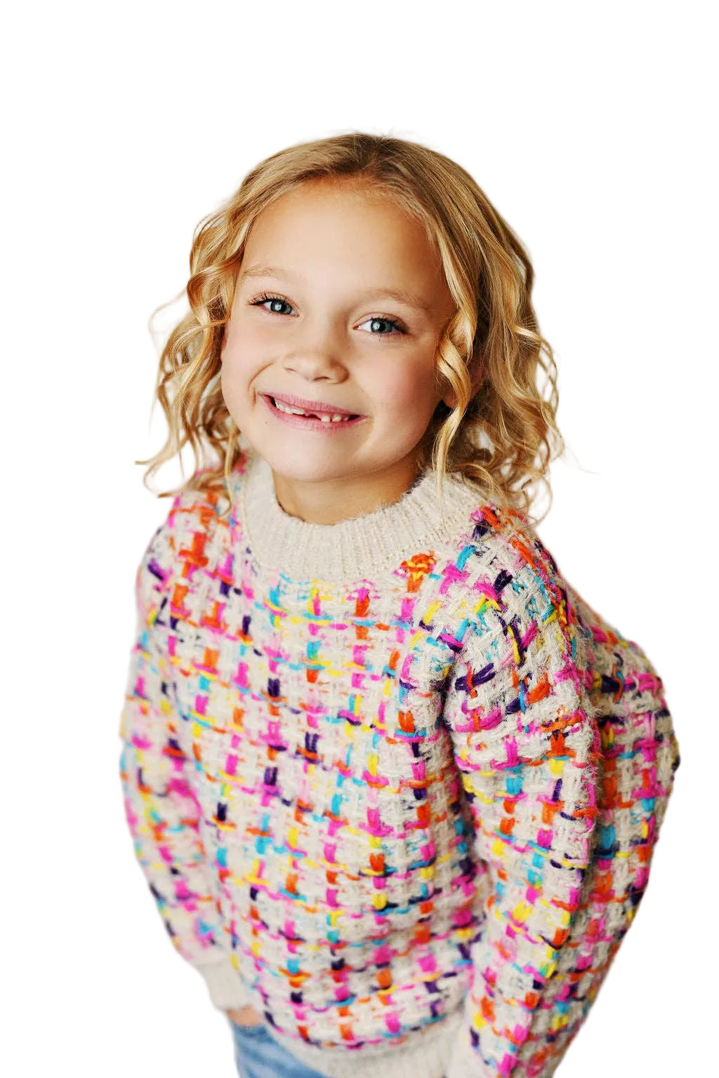 Child wearing a colorful sweater with a plain background