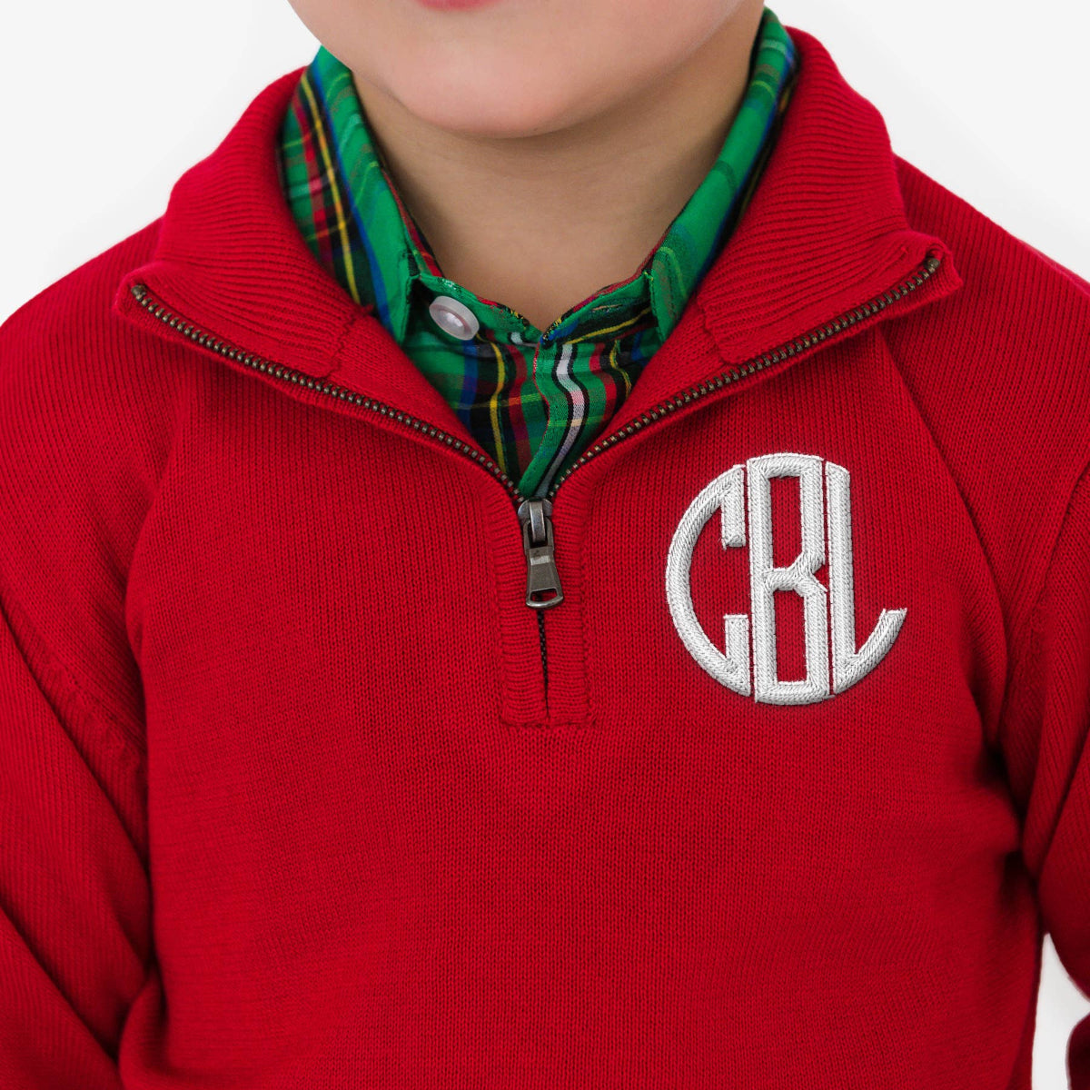 Red pullover with a monogram on a white background