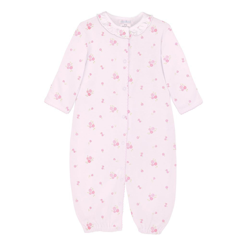 Baby girl pink knit converter gown with rose print, ruffle neckline, and snap closures.