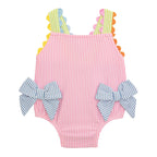 Pink striped seersucker girl's one-piece swimsuit with colorful ric-rac trim and blue bows on the hips.