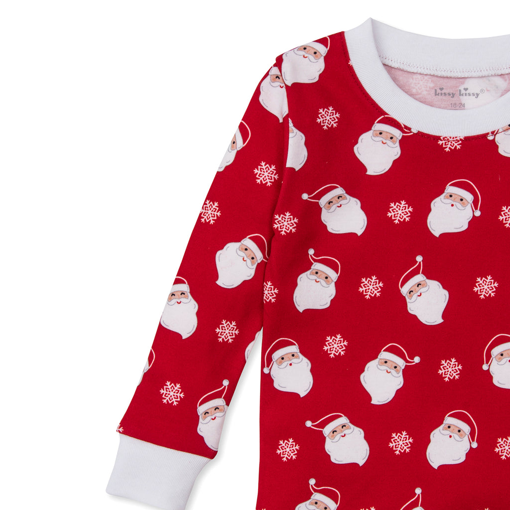 Red Pima cotton children’s Christmas pajama top with long-sleeves featuring allover Santa face print.