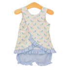 Back view of a toddler girl lemon print bloomer set with ruffled crossback design on a pink stripe top and blue bloomers.
