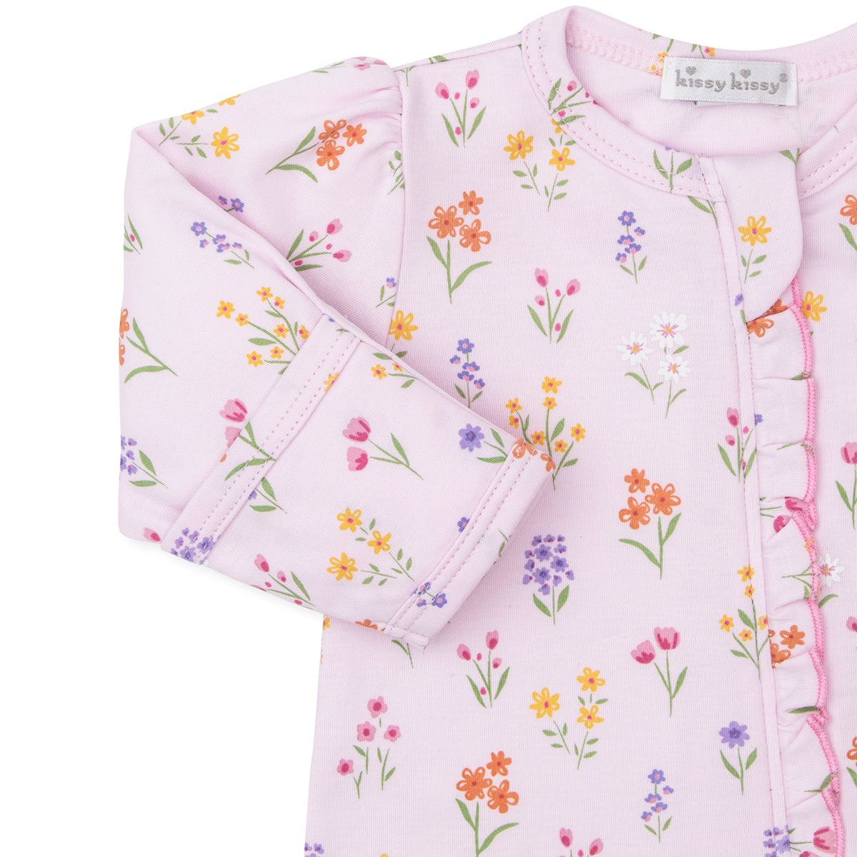 Folded baby girl footie with pink floral pattern and a ruffle 