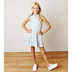 Young girl wearing a blue chintz floral zip-front tennis dress