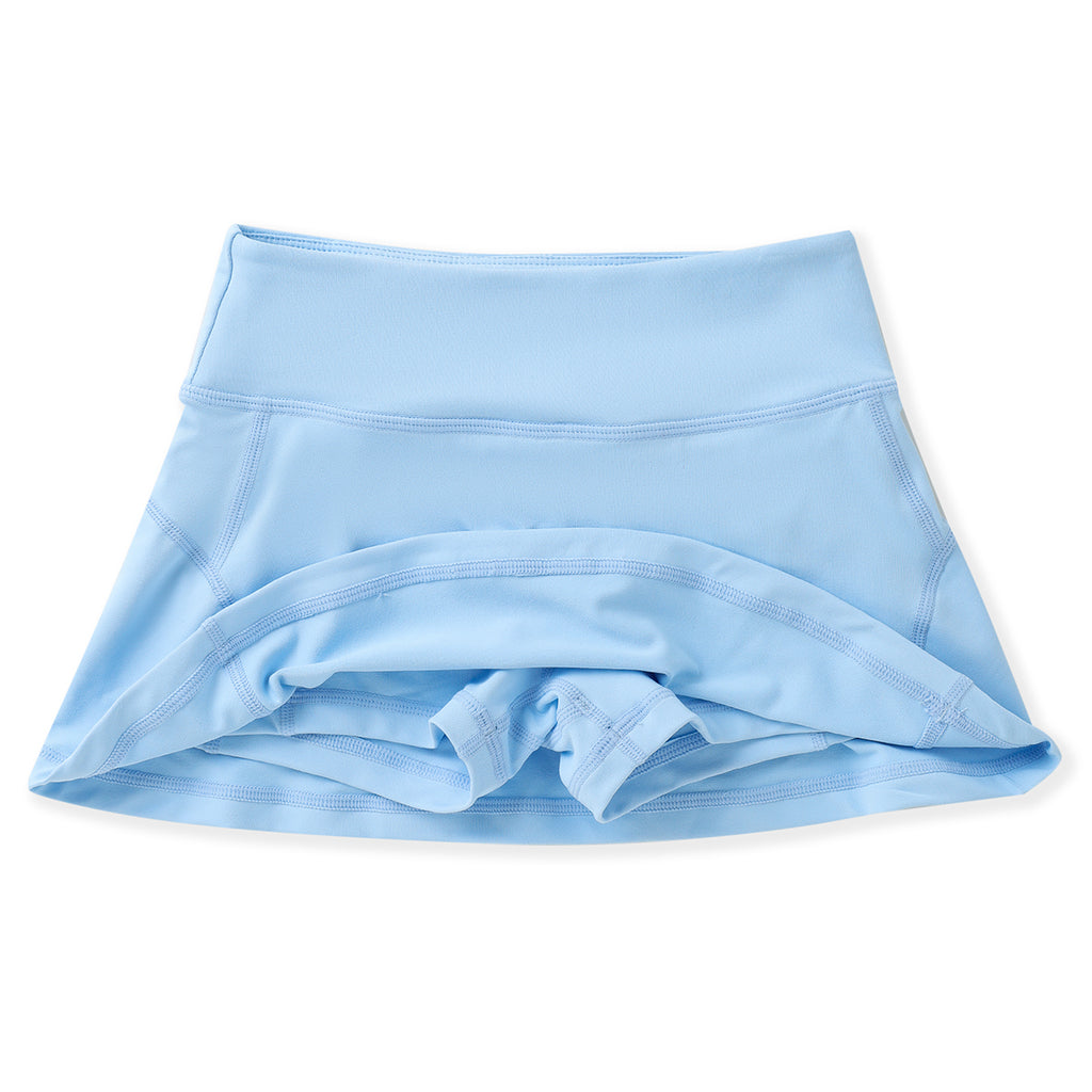 Girls blue athleisure tennis skirt with built-in shorts and back zipper pocket