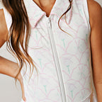 Close up of a girls pastel golf print zip tennis dress