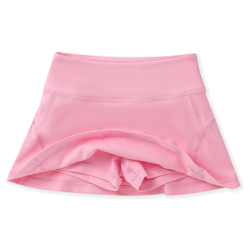 Girls pink athleisure tennis skirt with built-in shorts and back zipper pocket