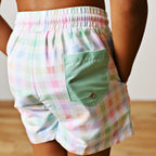 Back view of pastel plaid boy's swim trunks with an elastic waist soft green back pocket.