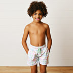 Young boy wearing a pastel check swimsuit with an elastic waist and green drawstring.