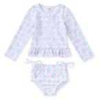 Girl's two-piece swimsuit with long-sleeve top and matching bottoms in a pink cherries print.