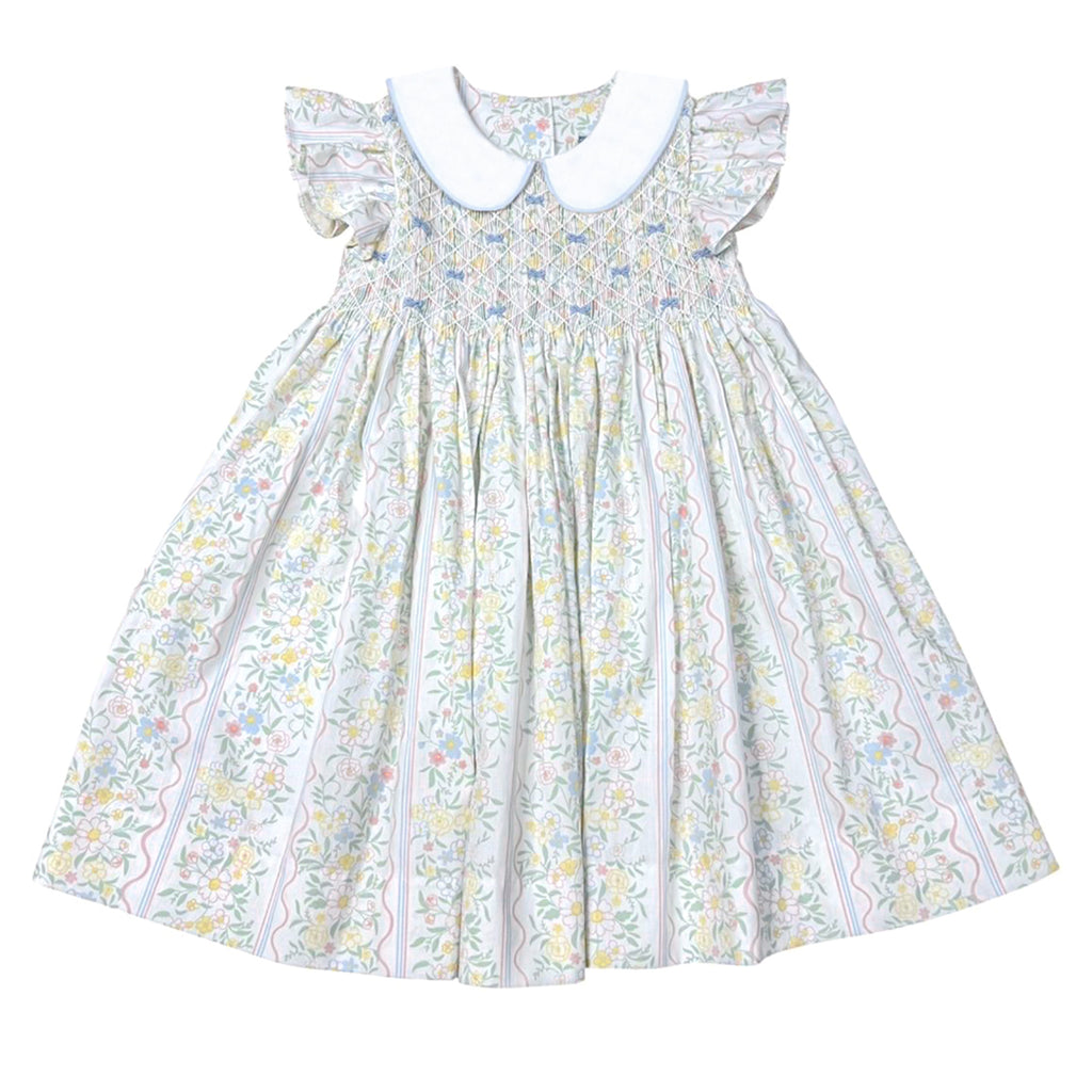 Girls pastel floral dress with flutter sleeves, a smocked bodice, blue bows, and a white peter pan collar.