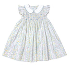 Girls pastel floral dress with flutter sleeves, a smocked bodice, blue bows, and a white peter pan collar.