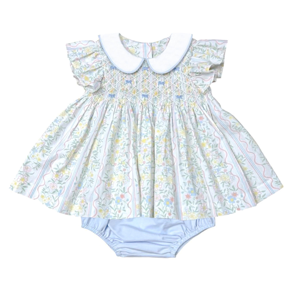 Baby girl bloomer set with pastel floral pattern, white peter pan collar, flutter sleeves, and light blue bloomers.