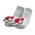 Grey striped baby socks with red tractor rattles on the toes