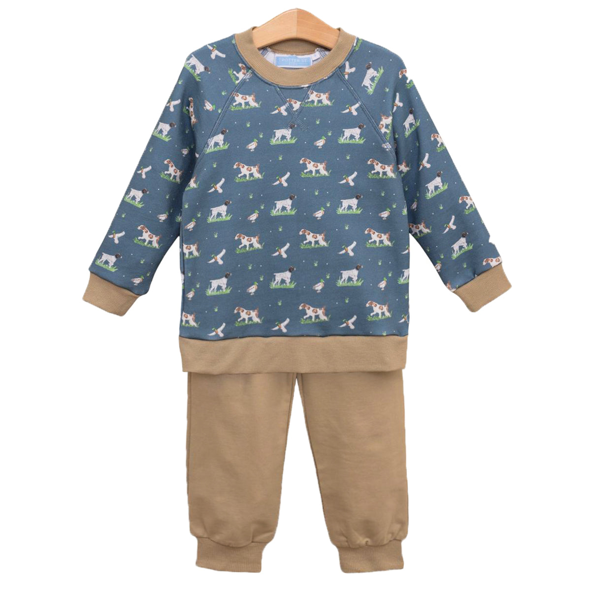 A boy's two-piece outfit that includes a long-sleeve sweatshirt in slate blue featuring an all-over print of hunting dogs and mallards with tan ribbed trim paired with solid tan jogger pants.