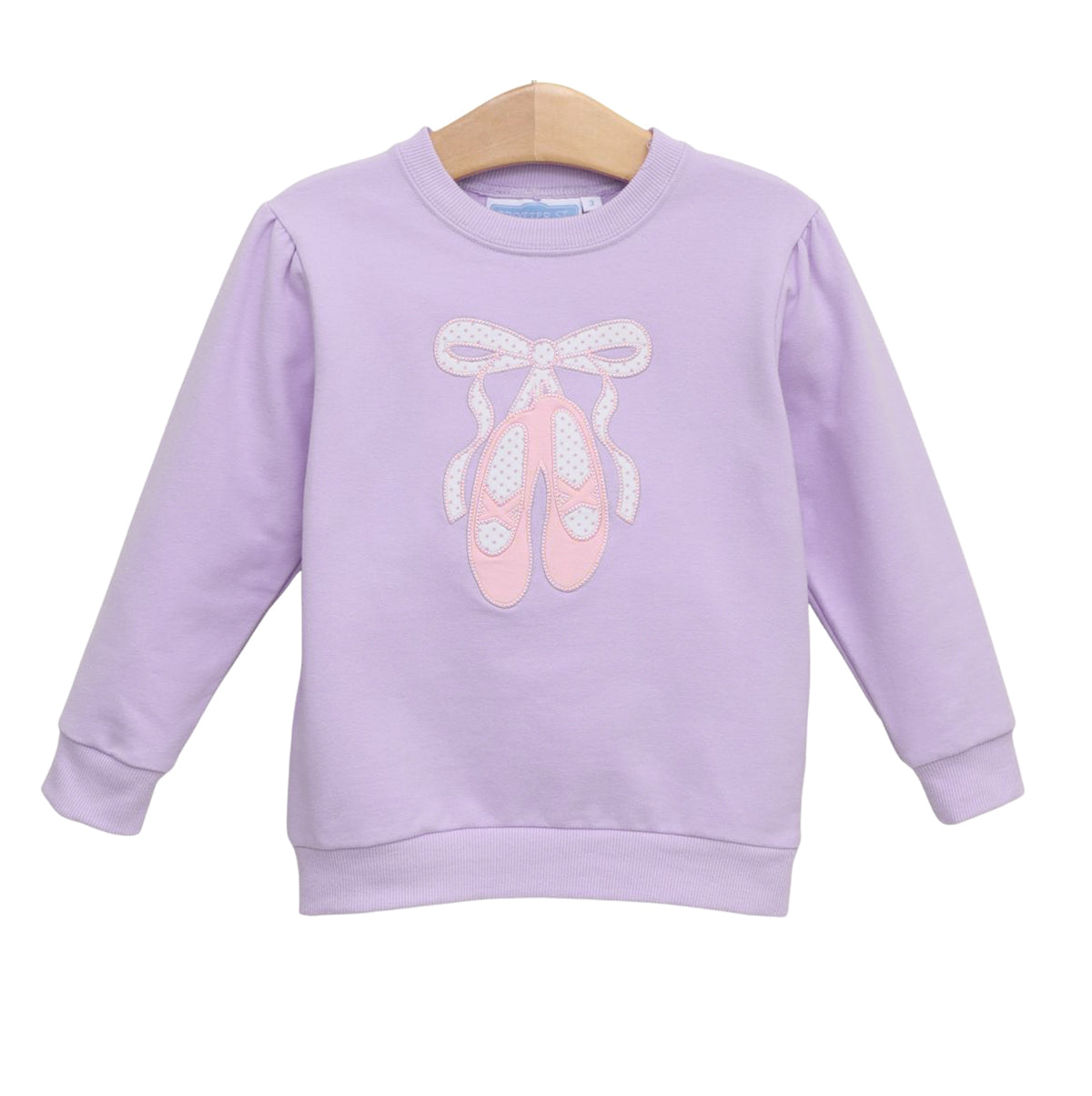 A girl's light purple long-sleeve sweatshirt featuring an applique of pink ballet shoes tied with a white polka-dotted ribbon on the front.