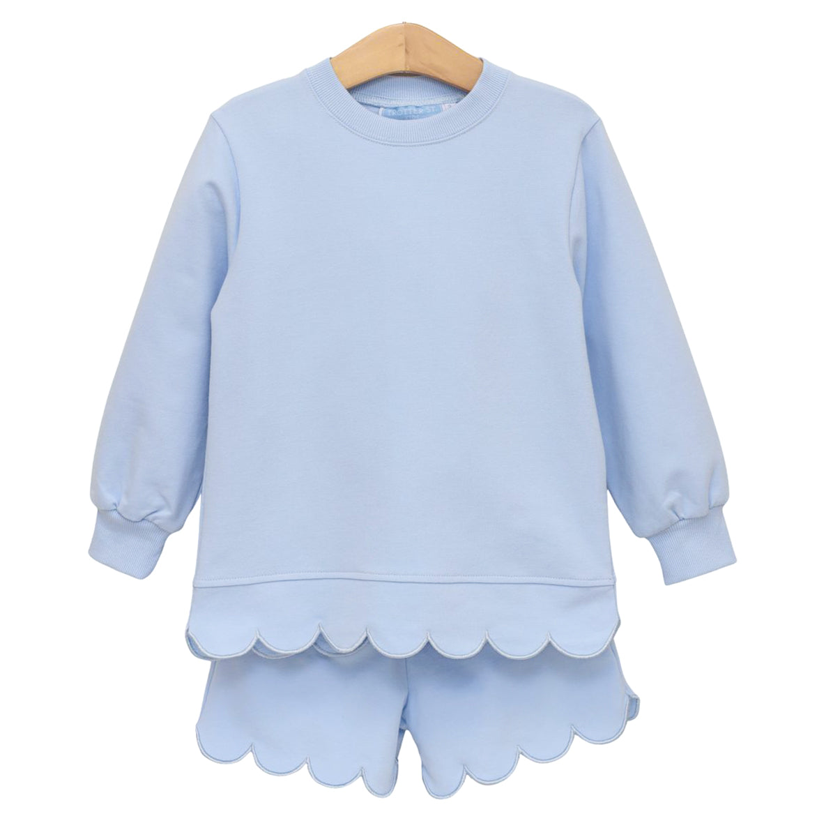 A light blue girl's long-sleeve sweatshirt and matching shorts set with scalloped hemlines.