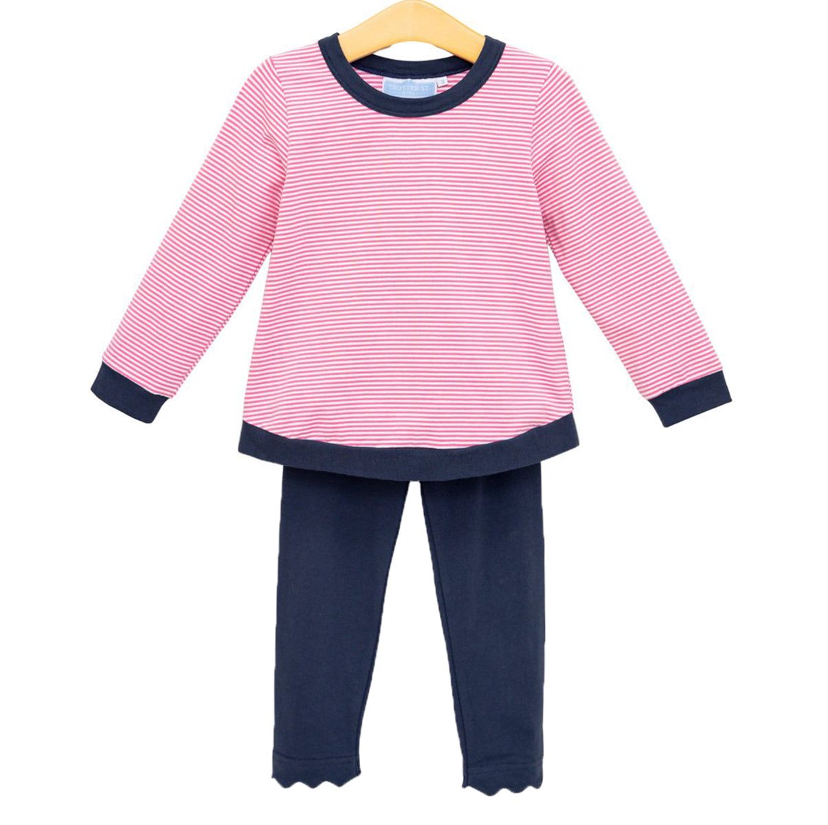 A little girl's two-piece outfit featuring a pink and white striped long-sleeve top with navy blue trim, paired with navy blue leggings with a scalloped hem.