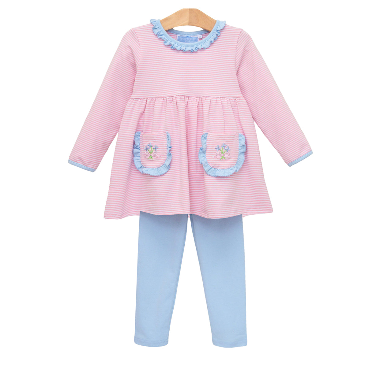 A toddler girl's two-piece outfit set consisting of a pink and white striped long-sleeve top with light blue ruffle trim and embroidered flower bouquet on the pockets, paired with light blue leggings.