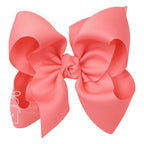 Large watermelon coral grosgrain classic hair bow with double knot center.