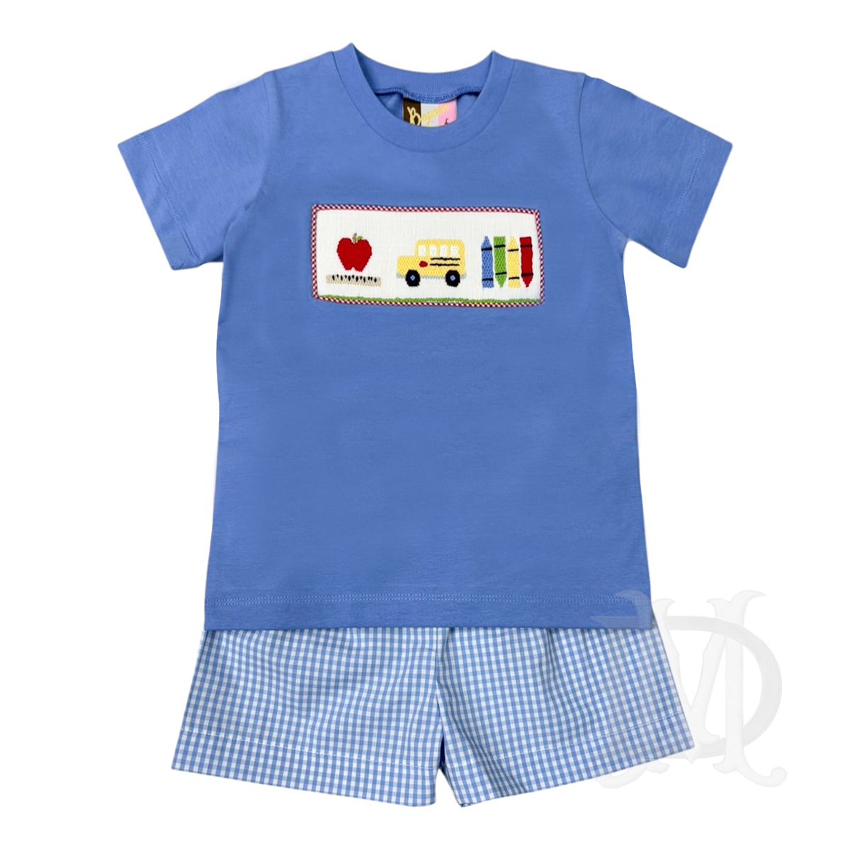 A toddler boy two-piece back to school outfit featuring a soft blue short-sleeve t-shirt with school-themed smocking on the chest, and matching blue and white gingham shorts.