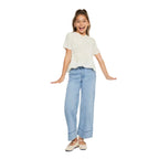 Young girl wearing a white blouse and light blue jeans on a white background