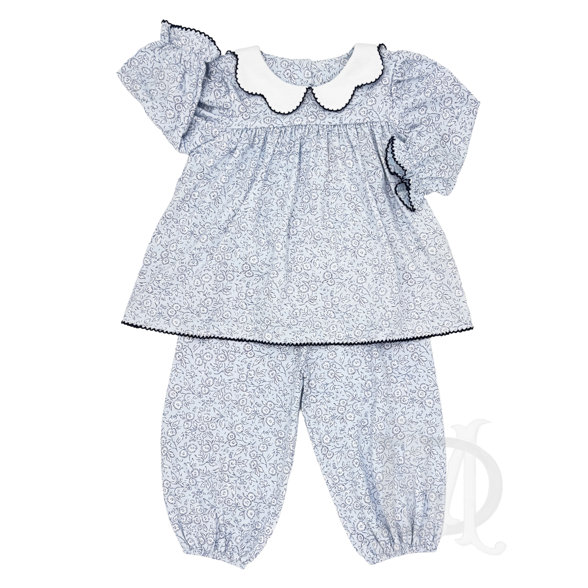 A baby girl's two-piece outfit set featuring a long-sleeve smocked blouse in a blue and white floral pattern, a white scalloped collar with navy trim, navy trim, and matching bloomer pants.